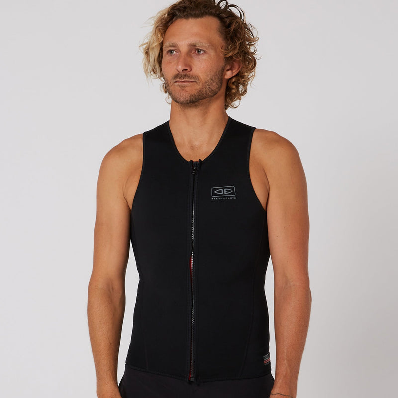 Load image into Gallery viewer, Man wearing a black sleeveless jacket with a logo on a light gray background